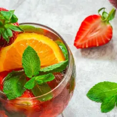 Orzeźwiający drink z truskawkami, pomarańczą i miętą, idealny do prosecco brut.