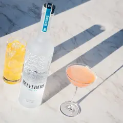 Wódka Belvedere 0.7 cena: elegancka butelka, drink w kieliszku i szklanka z lodem na marmurowym blacie.